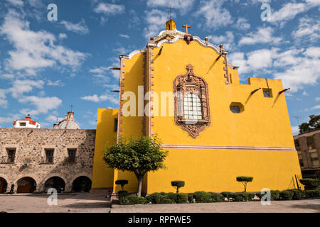 The facade of the Aranzazu Chapel and San Francisco Convent in the Plaza de Aranzazu in the state capital of San Luis Potosi, Mexico. The chapel and convent was built between 1749 and 1760 and features Churrigueresque details and tiled domes. Stock Photo