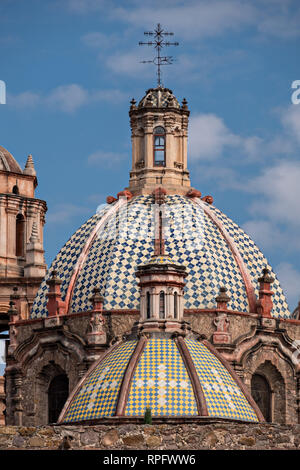 The tiled domes of the San Francisco Convent and the Aranzazu Chapel in the Plaza de Aranzazu in the state capital of San Luis Potosi, Mexico. The chapel and convent was built between 1749 and 1760 and features Churrigueresque details and tiled domes. Stock Photo