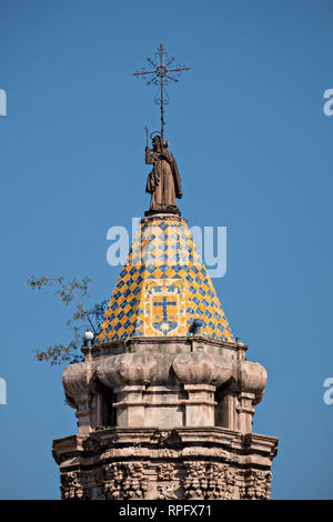 The tiled bell tower on the Baroque Churrigueresque style Iglesia del Carmen church and convent in the historic center on the Plaza del Carmen in the state capital of San Luis Potosi, Mexico. Stock Photo