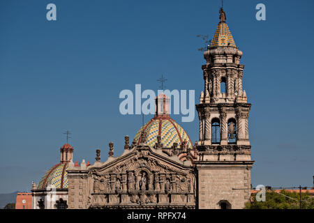 The tiled bell tower and domes on the Baroque Churrigueresque style Iglesia del Carmen church and convent in the historic center on the Plaza del Carmen in the state capital of San Luis Potosi, Mexico. Stock Photo
