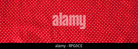 Red fabric with the white polka dots as a background texture composition. Stock Photo