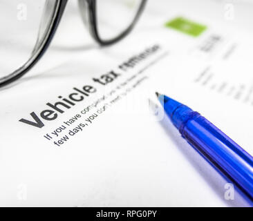 Detail of A Vehicle Tax Reminder Letter Or Form With Glasses And Pen On A Desk With Copy Space Stock Photo