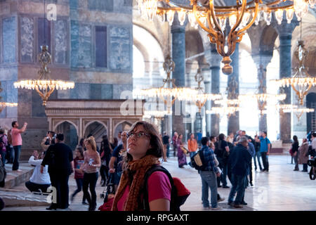 Istanbul, Turkey - April 8, 2012: Tourist visiting the interior of the religious mosque temple of Sultan Ahmed, known by Istanbul tourists as the Blue Stock Photo