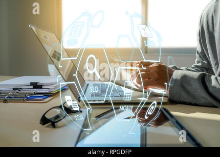 Man using  tablet computer  virtual interface graphic icons network diagram Digital marketing Stock Photo