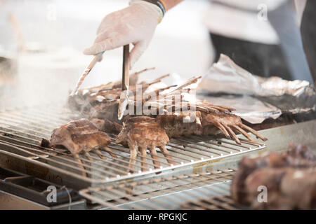closeup of a chef cooking  a lot of beef steaks on the barbeque Stock Photo