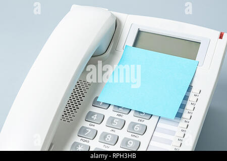 Blank sticky note on the telephone for your text or message. Stock Photo