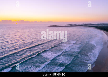 Aerial landscape of sunrise over ocean coastline near Arrawarra, New South Wales, Australia