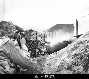 World War II, Iwo Jima - Marine Machine Gun Team Fires on Japanese Positions - HMG Browning M1917 Stock Photo