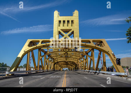 Tower bridge painted in gold color taken from the street and showing symmetry of the structure in  Sacramento, California Stock Photo