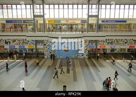 The inside of the main hall of Johannesburg train station, with people waiting their next transport, as seen from the second floor deck. Johannesburg, Stock Photo