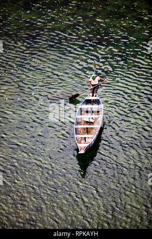 MEGHALAYA, INDIA, September 2018, Boatman rows his boat at Umngot River, Dawki Stock Photo