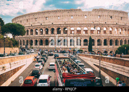 Rome, Italy - October 21, 2018: Colosseum. Red Hop On Hop Off Touristic Bus For Sightseeing In Street Near Flavian Amphitheatre. Famous World UNESCO L
