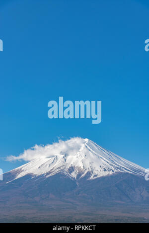 Close-up snow covered Mount Fuji ( Mt. Fuji ) in clear blue sky background on sunny winter season. Fujiyoshida City, Yamanashi Prefecture, Japan Stock Photo