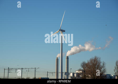 smoking pipes from powerplant and windmill Stock Photo