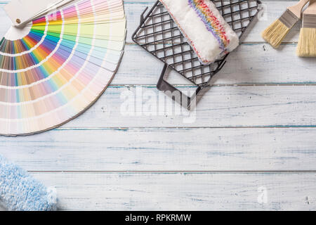 Top of view color palette brushes and other tools on wooden table. Stock Photo