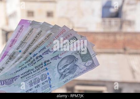 Indian rupee banknotes against old buildings Stock Photo