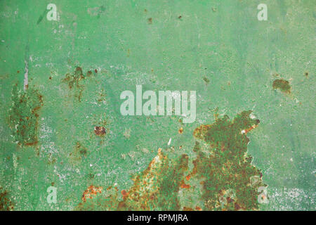 Multicolor background: rusty metal surface with green paint that cracks and cracks Stock Photo