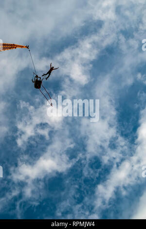 A male action sports thrill seeker jumping from a bungee platform. Stock Photo