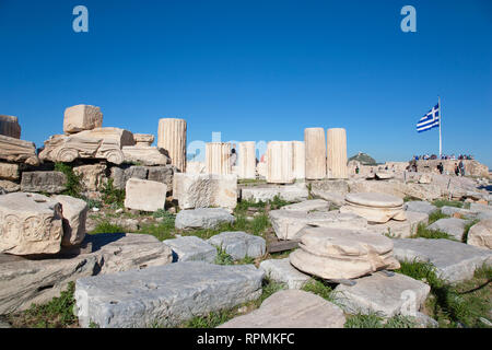 Greece, Attica, Athens, Acropolis ruins with tourists and large Greek flag. Stock Photo