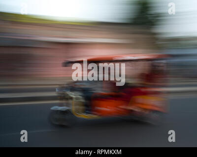 Blurred motion view of a battery operated rickshaw, Amer Road, Jaipur ...