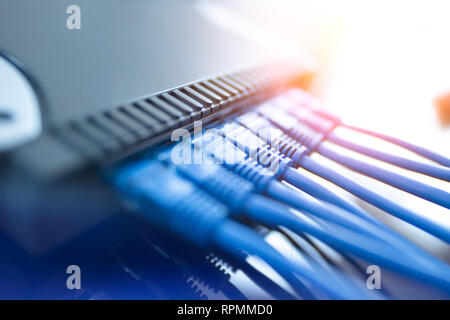 Network infrastructure, switch or router socket, cable connections. Ethernet, wired transmission, data center concept Stock Photo