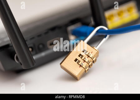 Network and data protection concept with padlock. Internet router or switch with cable plugged in. Stock Photo