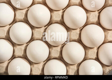 Many white eggs in egg carton Stock Photo