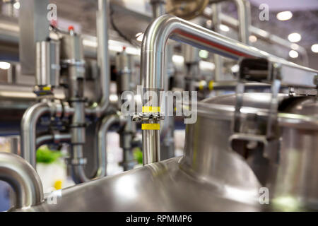 Milk pasteurization system is shown at a food and drink exhibition. Heat Treatments. Pasteurization is a process that kills microbes in food and drink Stock Photo