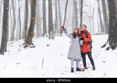 Couple of tourists standing on the mountain and rejoices the winter Stock Photo