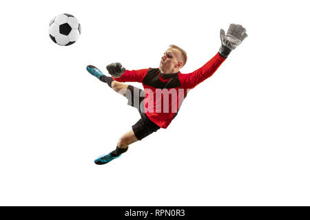 Male soccer player goalkeeper catching ball in jump. Silhouette of fit man with ball isolated on white studio background Stock Photo