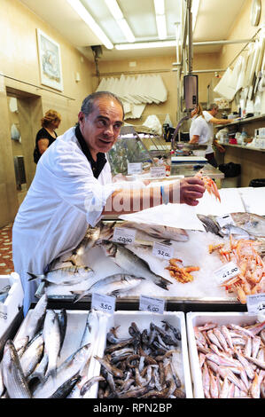 Unposed portrait of a fishmonger at Mercato di Mezzo, a popular covered market in Bologna, Italy Stock Photo