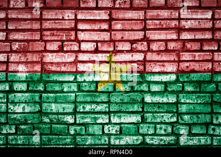 National flag of Burkino Faso on a brick background. Concept image for Burkino Faso: language , people and culture. Stock Photo