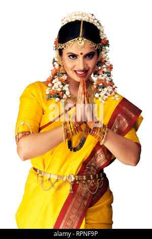A PORTRAIT OF A South Indian Bride dressed in traditional costume WITH HANDS FOLDED IN GREETING Stock Photo