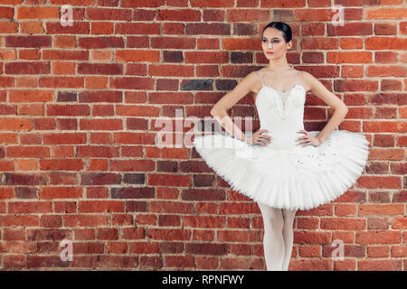 slender girl in stylish outfit looking aside indoors, close up photo, copy space Stock Photo