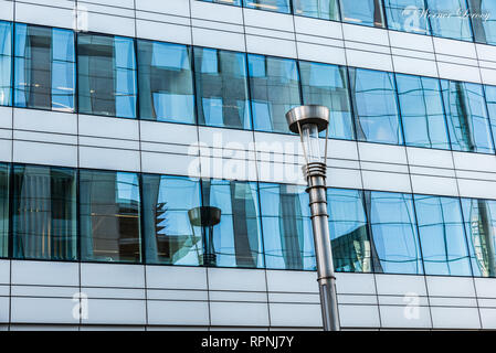 City of Brussels / Belgium - 02 15 2019: Abstract photography of the contemporary facade in glass and steel of a business company building Stock Photo