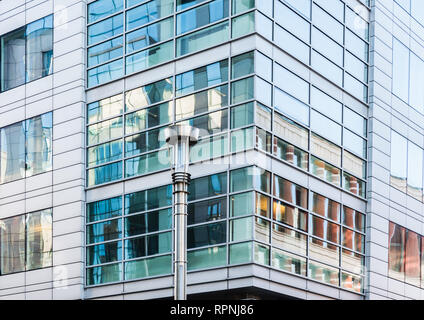 City of Brussels / Belgium - 02 15 2019: Abstract photography of the contemporary facade in glass and steel of a business company building Stock Photo