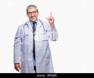 Handsome senior doctor man over isolated background pointing finger up with successful idea. Exited and happy. Number one. Stock Photo
