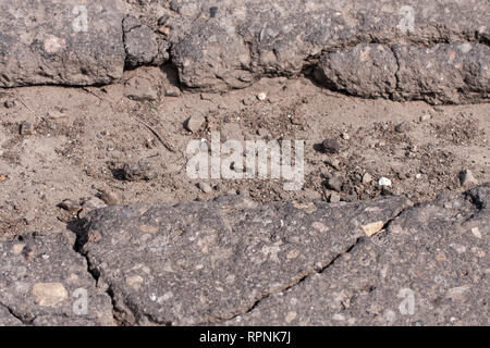 large pit with stones on the asphalt highway Stock Photo