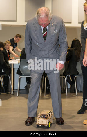 The Prince of Wales in his role of President, The Prince's Trust, has a remote control car built by students driven through his legs during a visit Ysgol Cwm Brombil co-educational school in Port Talbot, Wales, which is involved in delivering The Trust's Achieve programme. Stock Photo