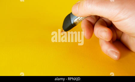a man's hand draws with a 3d printer pen on a yellow background, footage ideal for topics such as innovation, technology Stock Photo