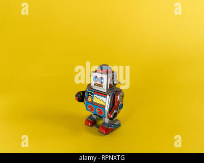 vintage metal robot on yellow background Stock Photo