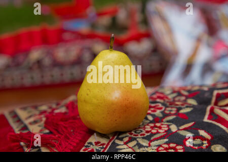 Large yellow pear in the carpet . Full depth of field. Autumn harvest concept - Fresh ripe organic yellow pears , dark stone background. Vegetarian, v Stock Photo