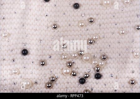 Knitted texture with multi-colored pearls. Abstract Background. Stock Photo