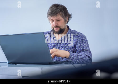 Male focussed on work. Working at home. Creative media marketing manager doing importnant tasks, have busy working schedule. Businessman dressed Stock Photo