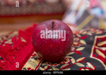 Large red apple in the carpet . Full depth of field. Autumn harvest concept - Fresh ripe organic red apple , dark stone background. Vegetarian, vegan, Stock Photo