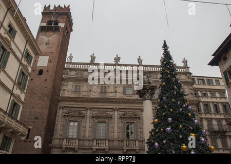 Italy, Verona - December 08 2017: the view of New Year Tree, Torre del Gardello and  Maffei palace at Piazza delle Erbe on December 08 2017, Veneto. Stock Photo