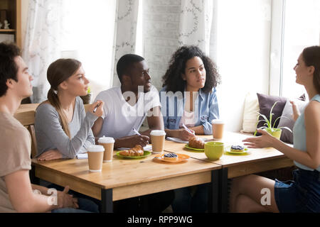 Multiracial students studying together in cafe, brainstorm, share ideas Stock Photo