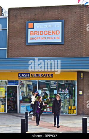 Welcome Sign outside the modern Bridgend Shopping Centre, above the Cash Generator shop. Young People walking past. Stock Photo