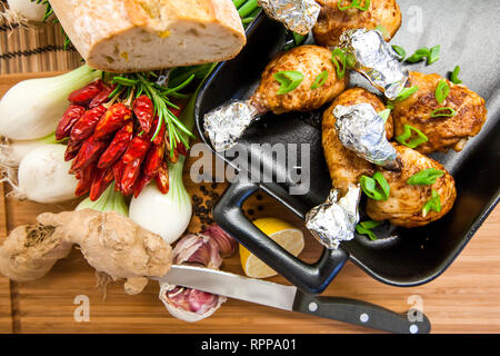 Delicious roasted chicken legs in a casserole dish Stock Photo