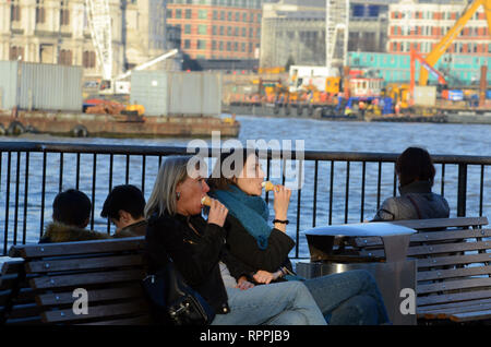 London, UK. 22nd Feb, 2019. Enjoying an ice cream on the South Bank of the Thames on the hottest day in February. Credit: JOHNNY ARMSTEAD/Alamy Live News Stock Photo